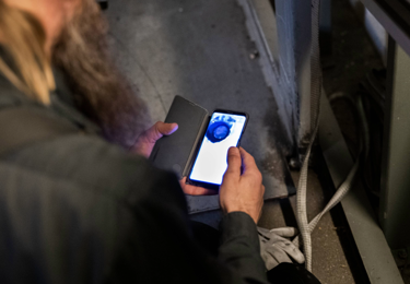 Elektriker med mobiltelefon i handen